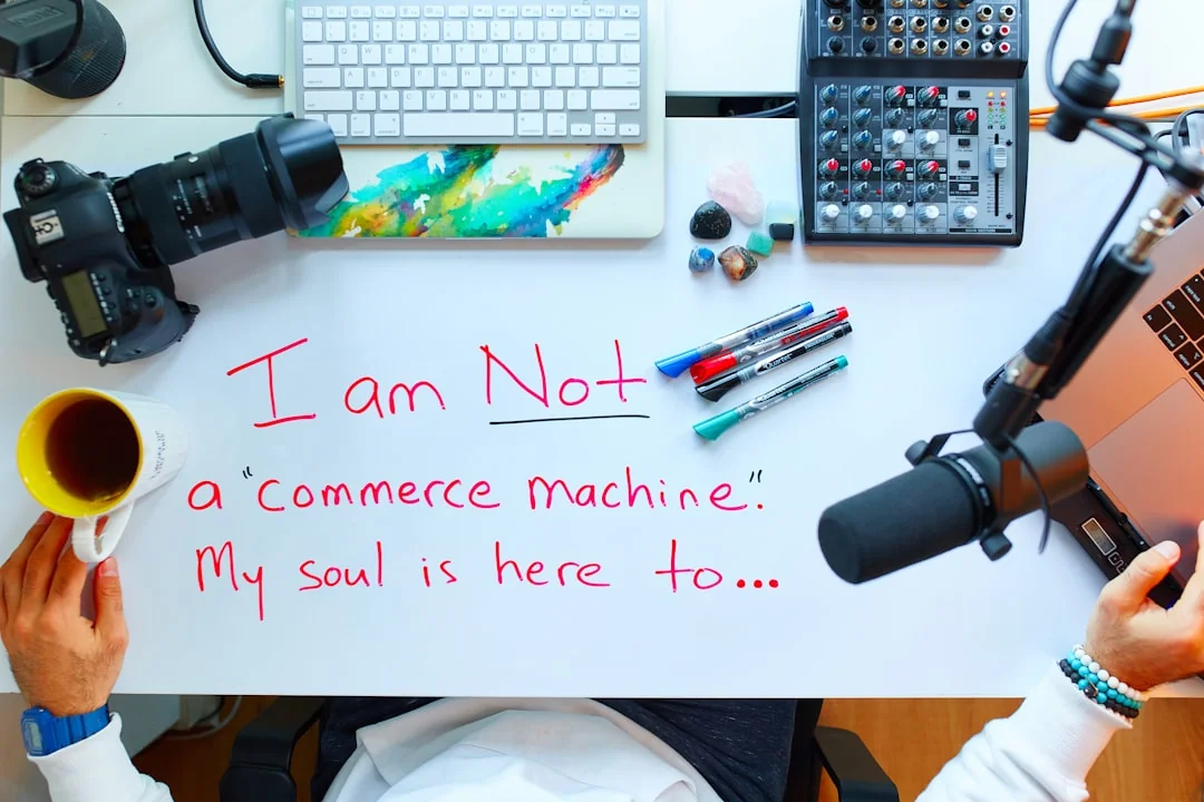 Person analyzes stock data with a smartphone and laptop, indoors.
